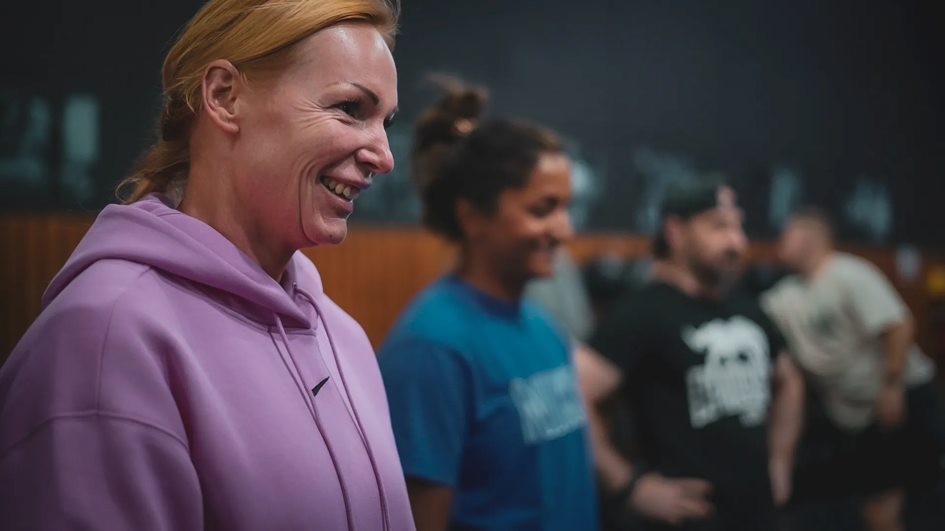 I Am Athletics member lifting barbell