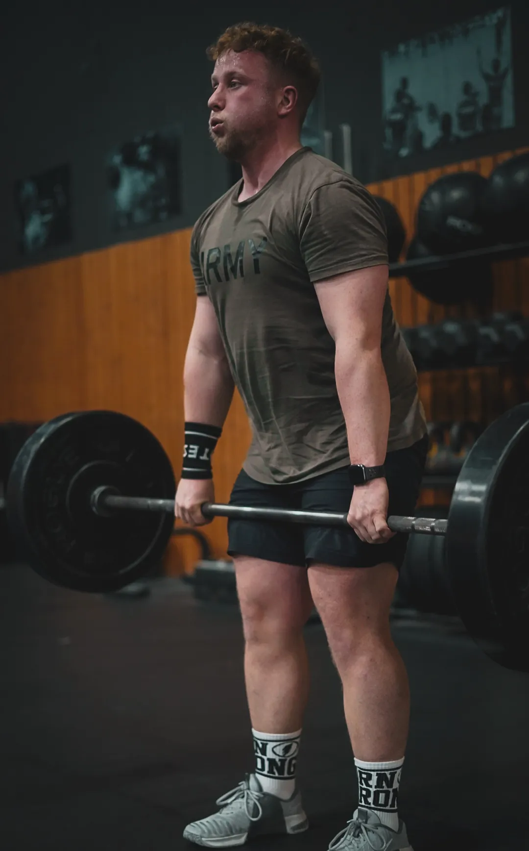 I Am Athletics member lifting barbell